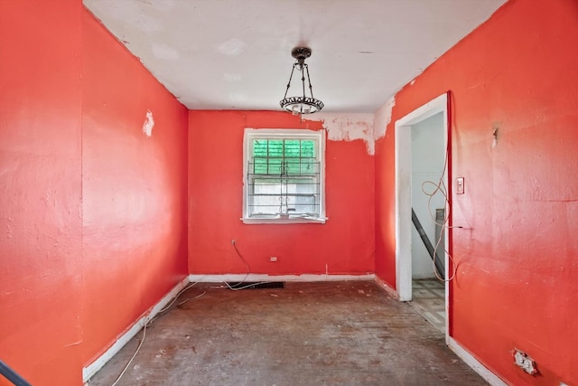 unfurnished room featuring baseboards