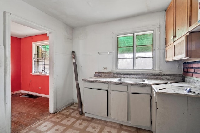 kitchen with light floors, light countertops, and a sink