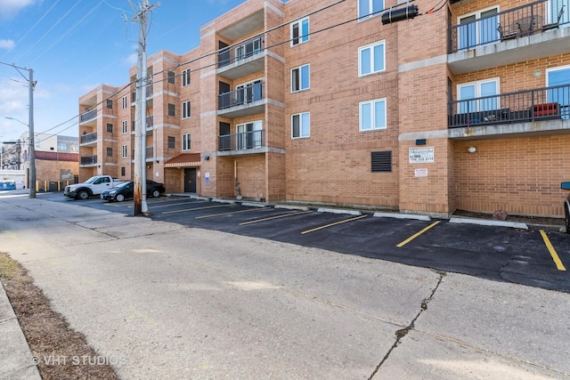 view of building exterior featuring uncovered parking