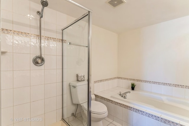 bathroom with visible vents, toilet, a stall shower, and a garden tub