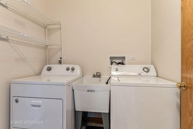 laundry area with a sink, separate washer and dryer, and laundry area