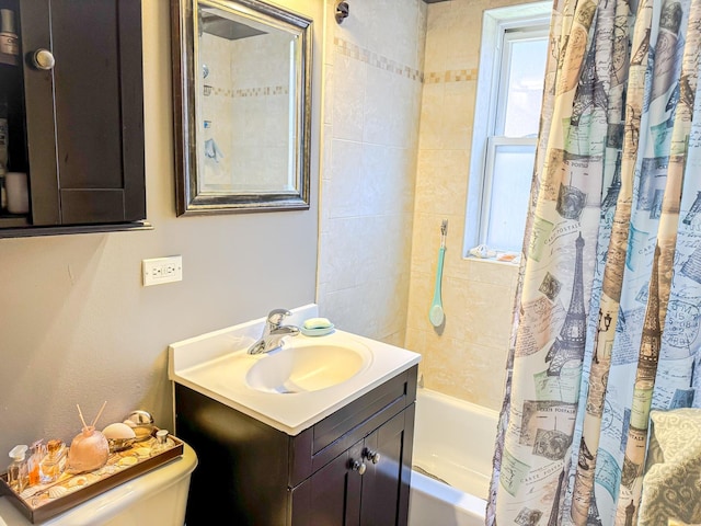 full bathroom featuring toilet, shower / bath combo, and vanity