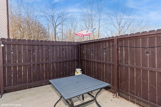 view of patio with a gate and fence