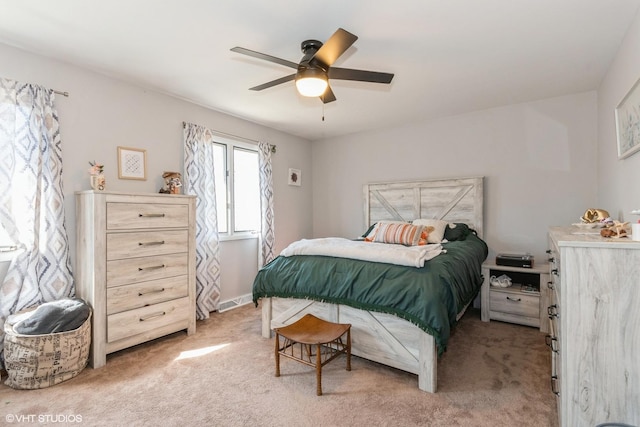 bedroom with light colored carpet and a ceiling fan