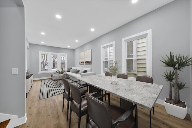 dining room featuring recessed lighting, baseboards, and light wood finished floors