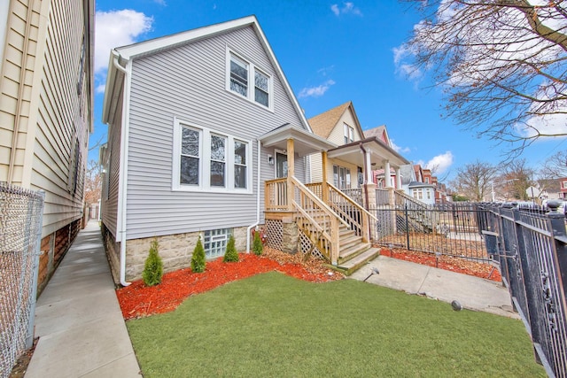 bungalow-style home featuring a residential view, fence, and a front yard