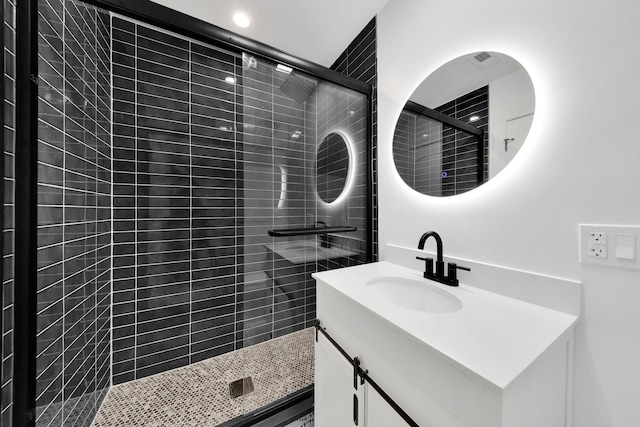 full bathroom featuring a stall shower and vanity