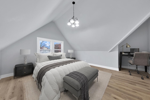 bedroom with vaulted ceiling, light wood finished floors, a notable chandelier, and baseboards