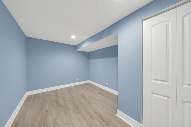 interior space with baseboards and wood finished floors