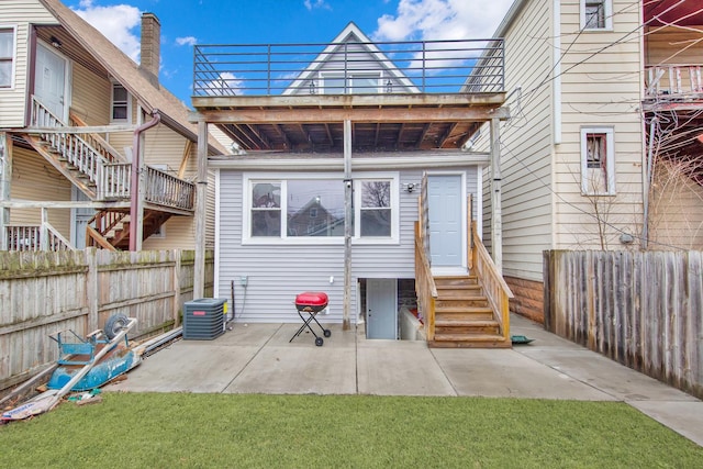 back of property with entry steps, central air condition unit, fence, and a patio