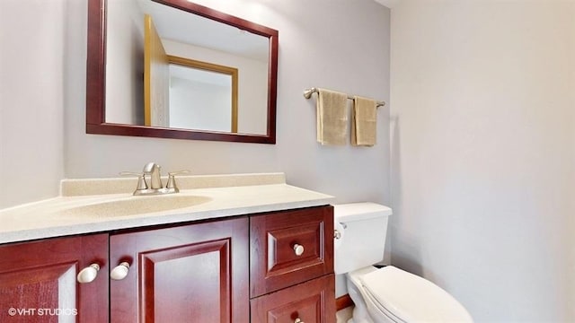 bathroom with toilet and vanity