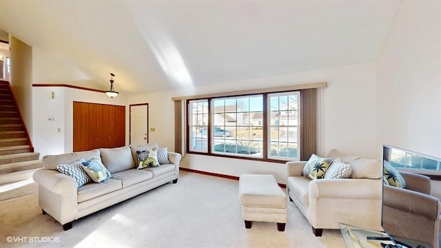 carpeted living room with stairs and baseboards