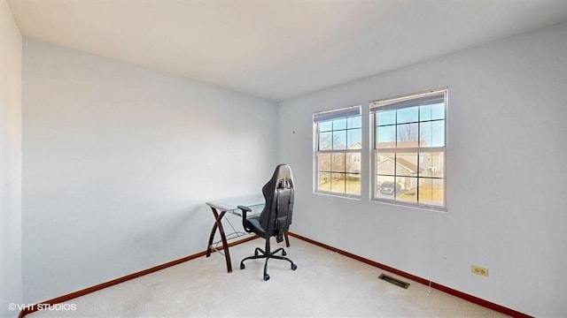 carpeted office space featuring baseboards and visible vents