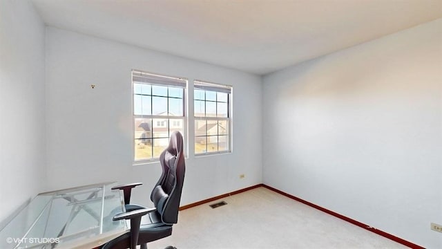 home office with light carpet, visible vents, and baseboards