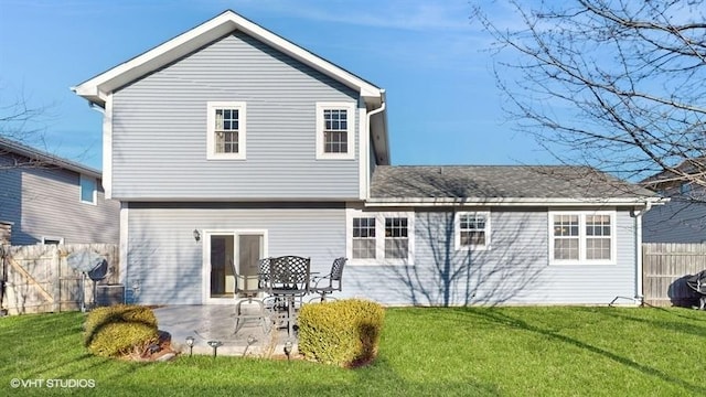 rear view of house with a patio, a yard, and fence