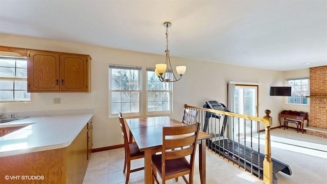 dining room featuring baseboards and a chandelier