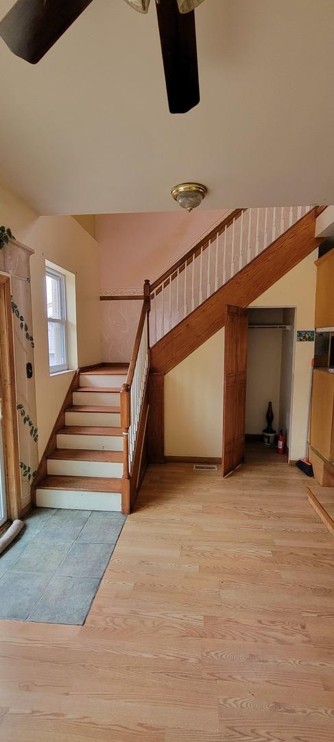 staircase with wood finished floors