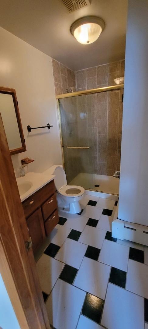 full bath with vanity, toilet, visible vents, and a stall shower