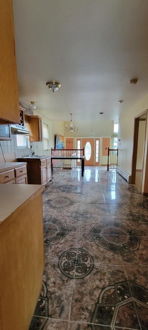 kitchen featuring marble finish floor and a chandelier