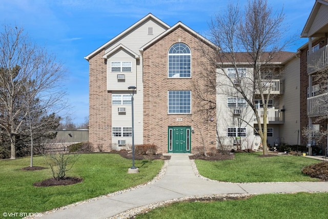 view of front of house with brick siding and a front yard