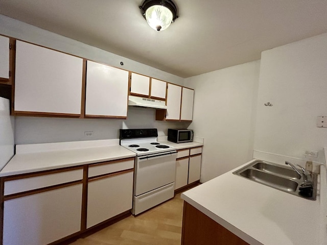 kitchen featuring light countertops, white electric range, a sink, and under cabinet range hood