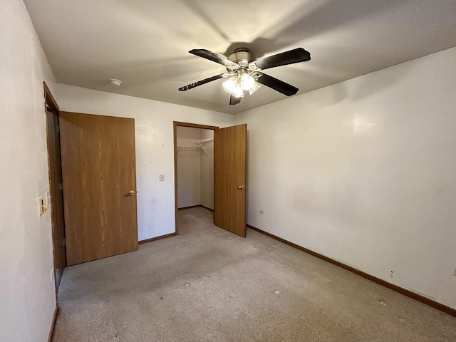 unfurnished bedroom featuring light carpet, a closet, and baseboards