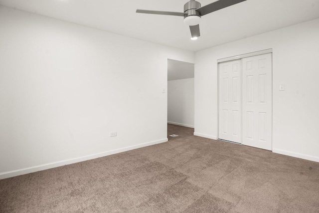 unfurnished bedroom with a ceiling fan, carpet flooring, baseboards, and a closet