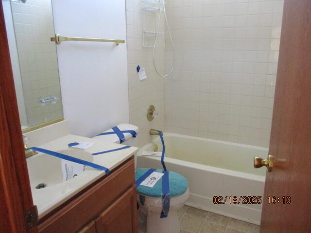 bathroom featuring tub / shower combination, tile patterned flooring, and vanity