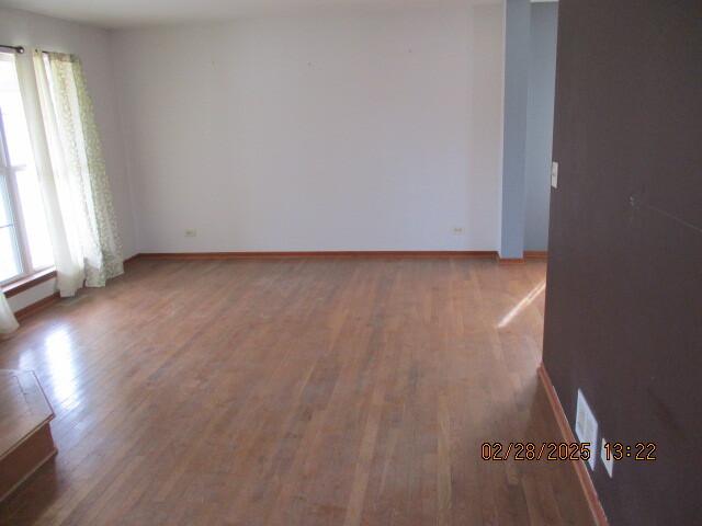 unfurnished room featuring wood finished floors and baseboards