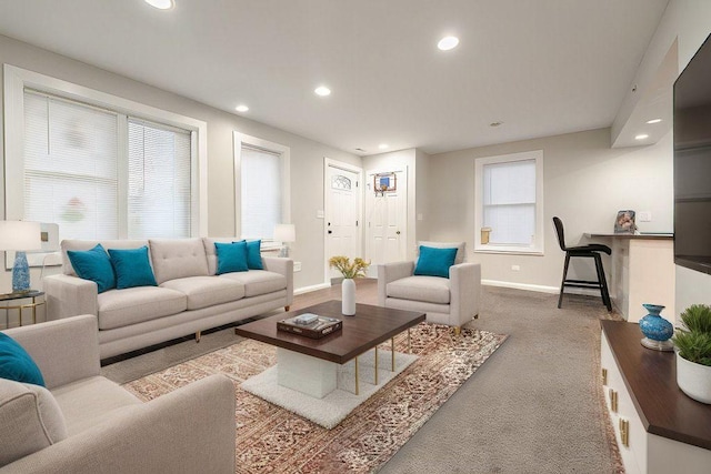 living area with carpet, baseboards, and recessed lighting