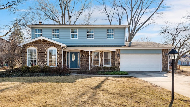 traditional-style home featuring brick siding, a front lawn, concrete driveway, a chimney, and an attached garage