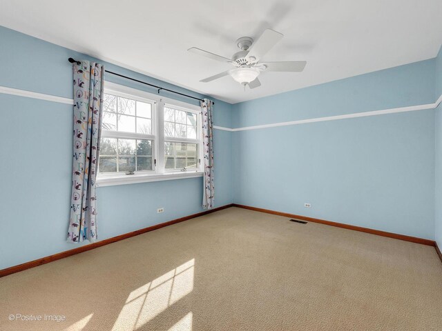 unfurnished room featuring visible vents, baseboards, a ceiling fan, and carpet flooring