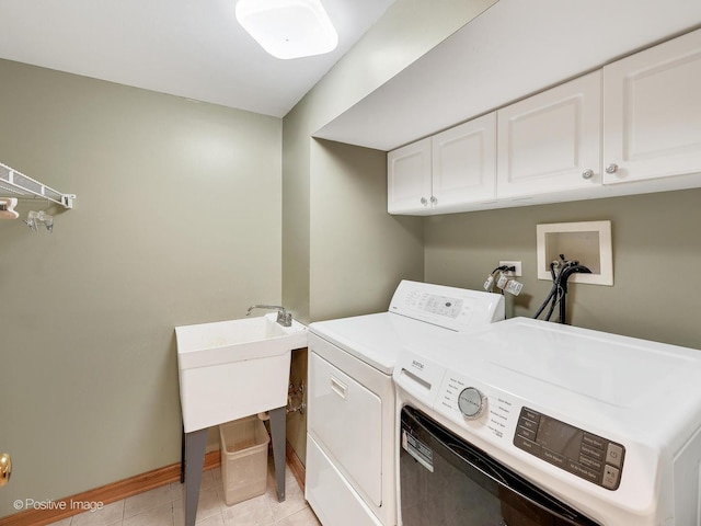 laundry area with light tile patterned flooring, cabinet space, independent washer and dryer, and baseboards