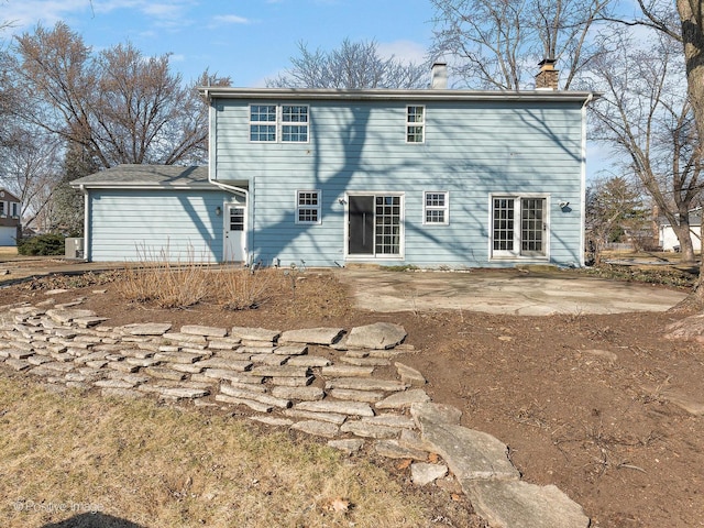 back of property with a patio area and a chimney