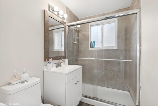 full bath with a shower stall, toilet, and vanity