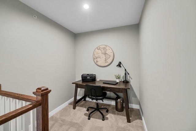 office area with light carpet and baseboards