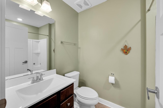 full bath with baseboards, visible vents, toilet, walk in shower, and vanity