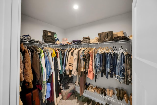 walk in closet with carpet floors