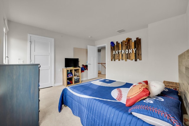 bedroom with visible vents and carpet flooring