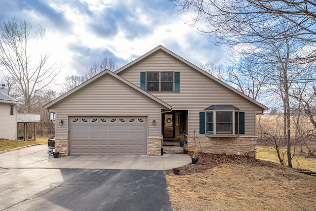 view of front of house with stone siding, an attached garage, and driveway