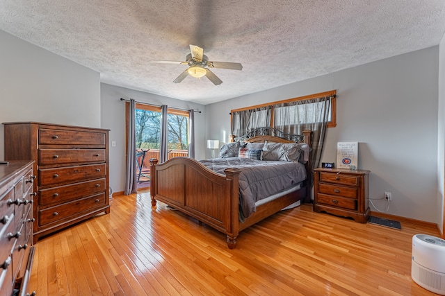 bedroom with access to exterior, a ceiling fan, a textured ceiling, light wood-type flooring, and baseboards