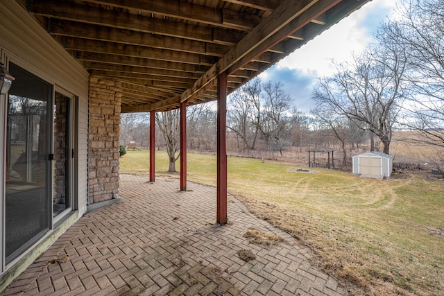 view of patio with an outbuilding and a shed