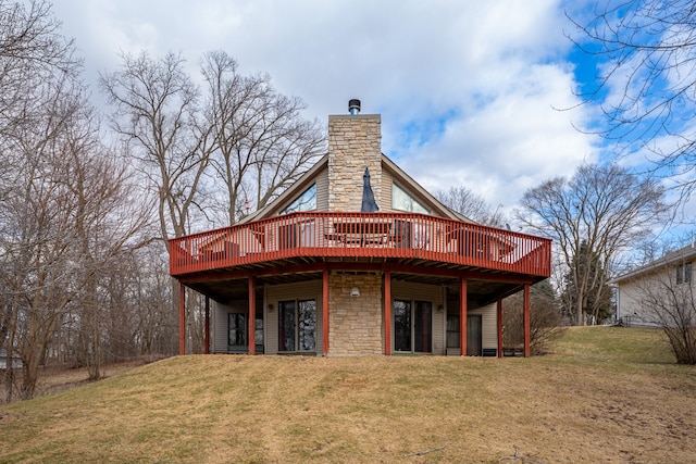 back of house with a yard, a chimney, and a wooden deck