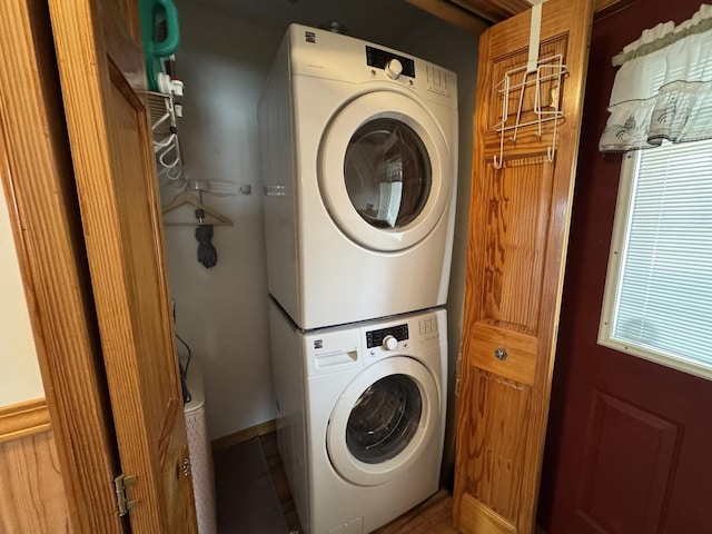 laundry room with stacked washing machine and dryer