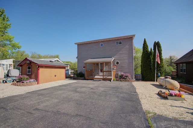view of front of property with central AC, an outdoor structure, and a wooden deck