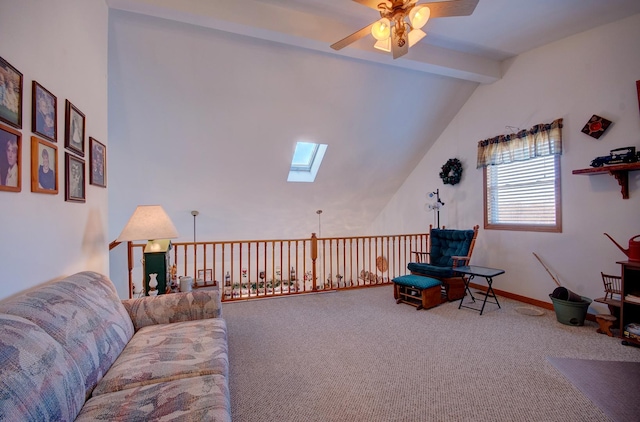 living area with a skylight, ceiling fan, and carpet floors