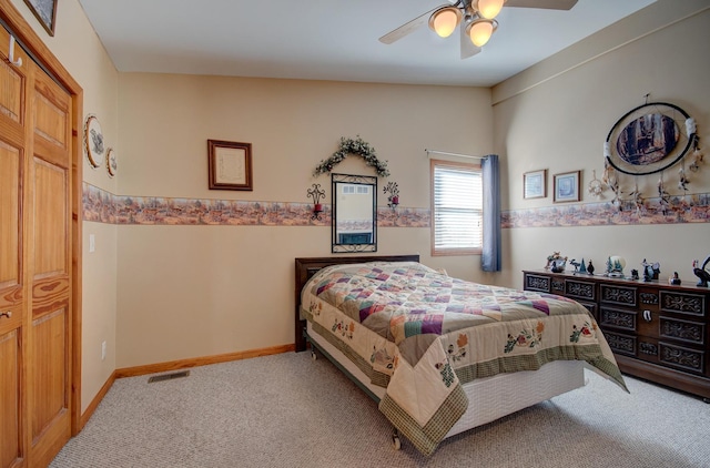 carpeted bedroom featuring ceiling fan and baseboards