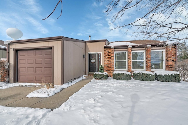 view of front of house with a garage and brick siding