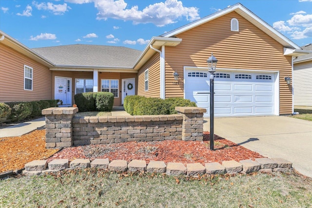 ranch-style home with a garage and driveway