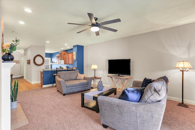 living area with light tile patterned floors, a ceiling fan, baseboards, recessed lighting, and light colored carpet